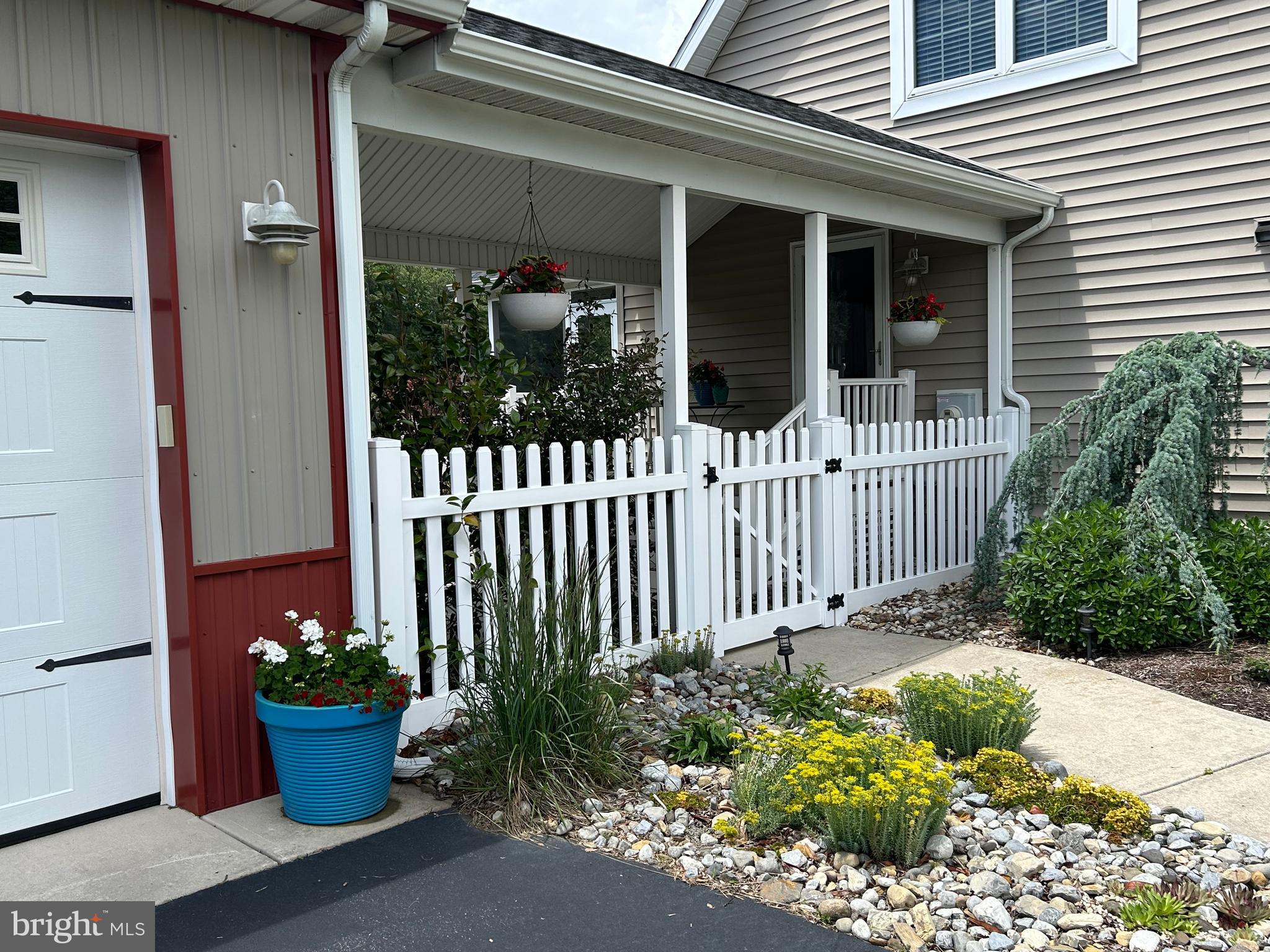 20346 Cool Spring Road Milton, DE 19968 - Photo 5 of 67 a view of a house with a garden and potted plants