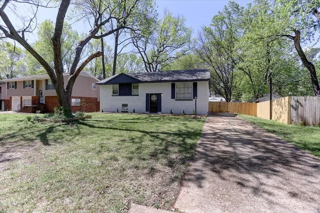 a house that has a tree in front of it
