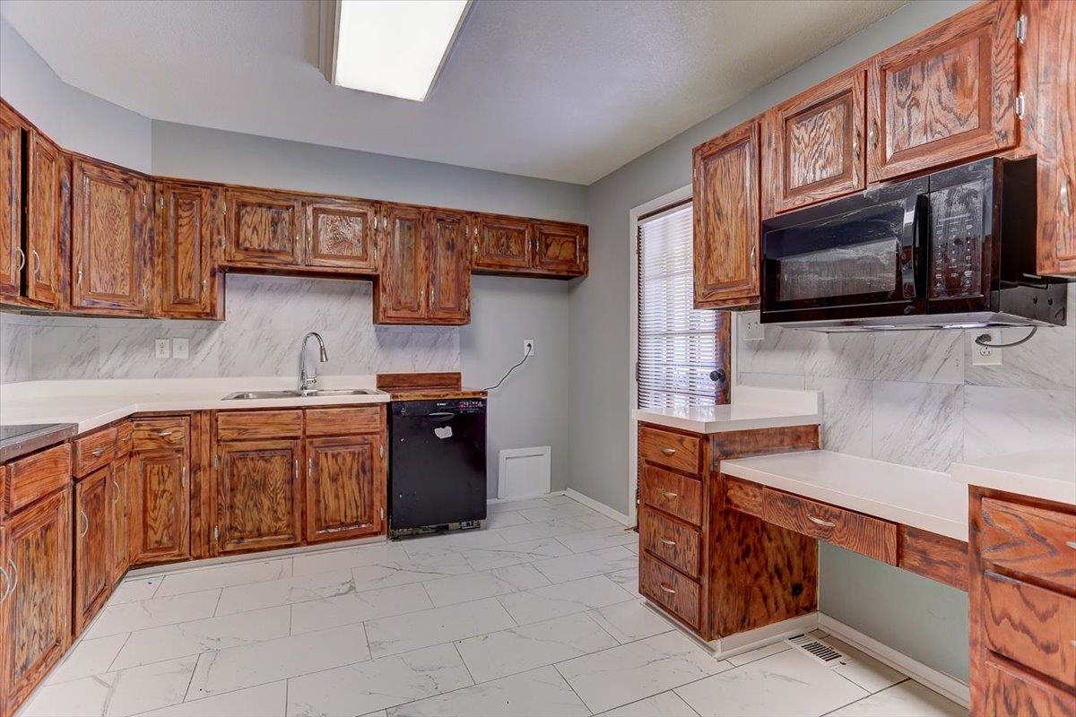 3263 Glen Logan Road Memphis, TN 38134 - Photo 13 of 40 a kitchen with stainless steel appliances granite countertop a stove microwave and cabinets