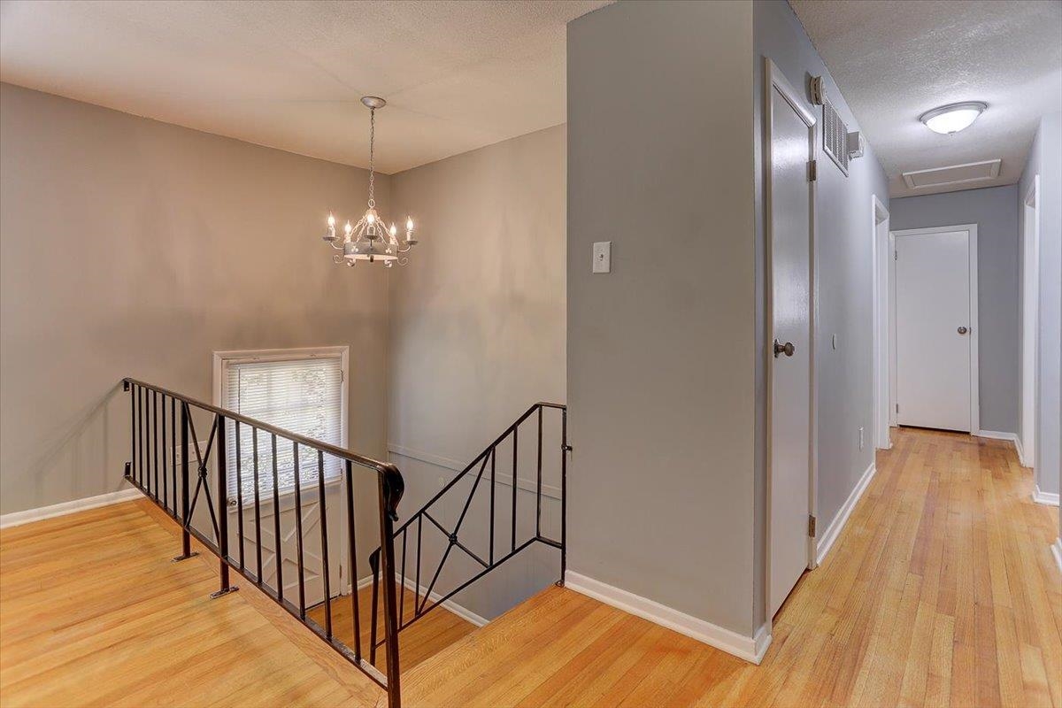 3263 Glen Logan Road Memphis, TN 38134 - Photo 5 of 40 a view of a hallway with wooden floor and staircase