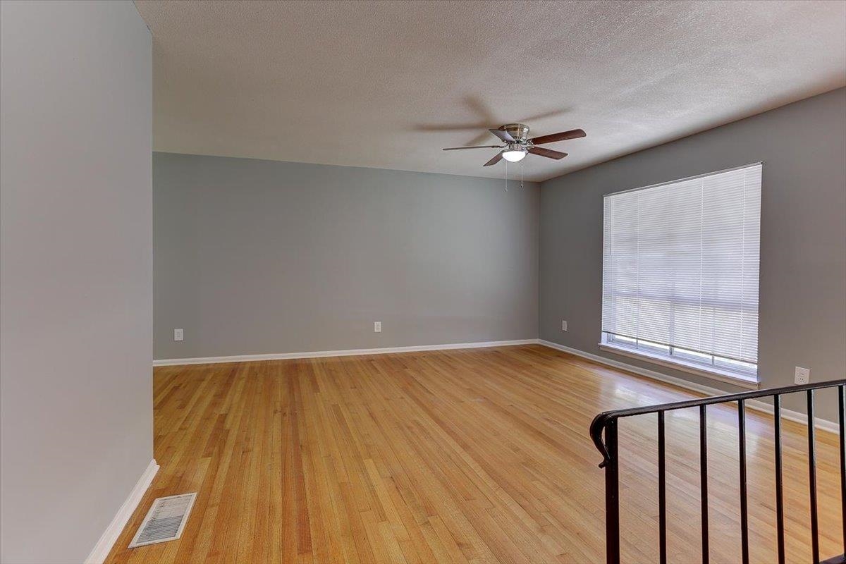 3263 Glen Logan Road Memphis, TN 38134 - Photo 7 of 40 an empty room with windows and fan