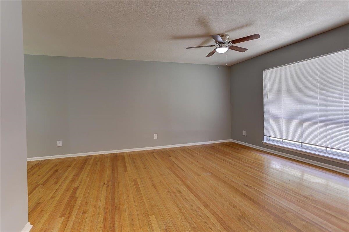 3263 Glen Logan Road Memphis, TN 38134 - Photo 10 of 40 wooden floor in an empty room with a window