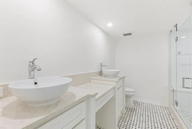 an empty room with a window and a ceiling fan