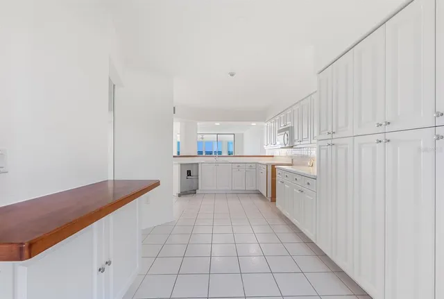 a kitchen with white cabinets appliances and a sink