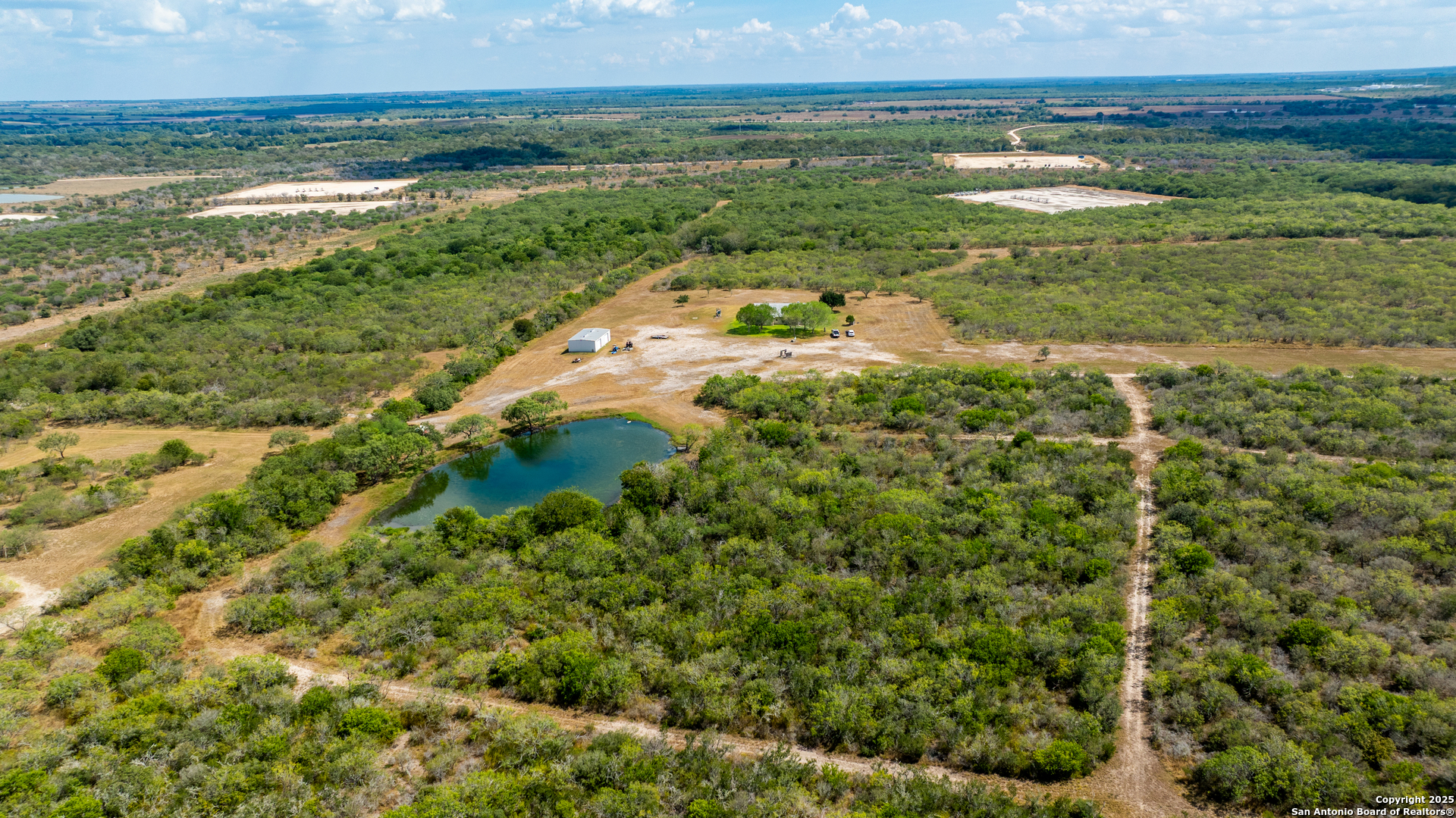 a view of a lake with a field