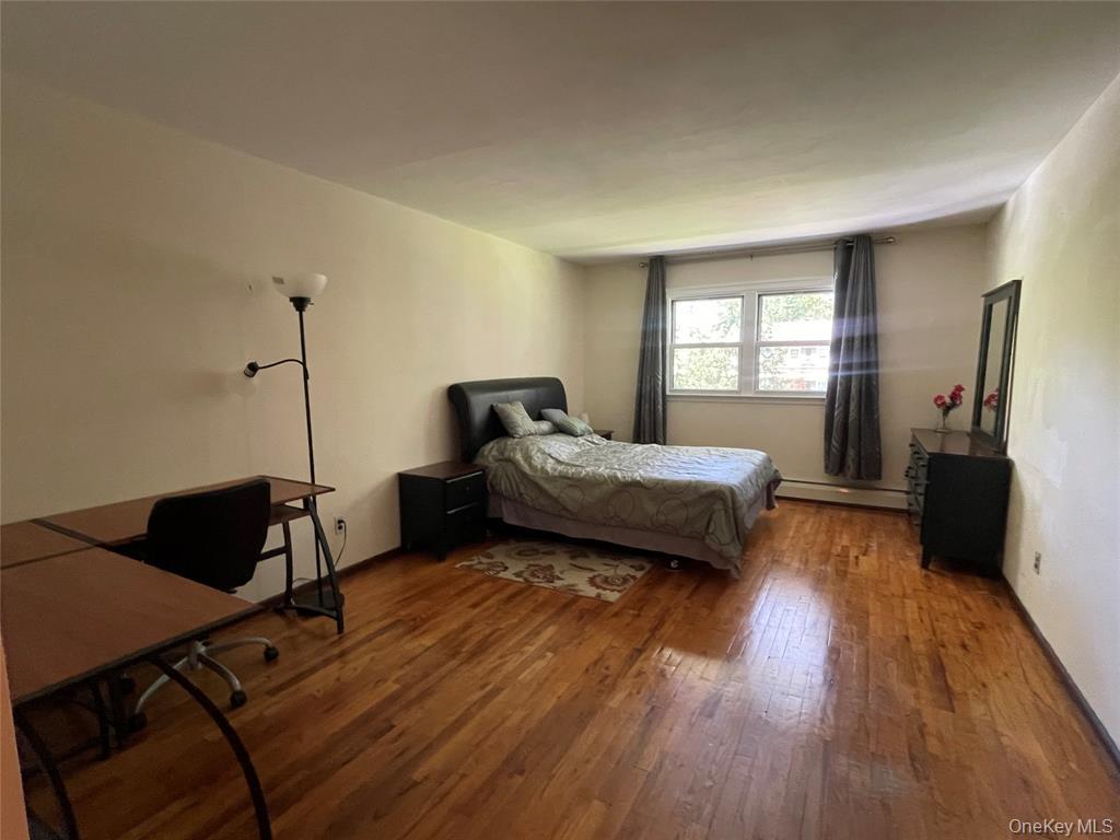 4 Cornwallis Road East Setauket, NY 11733 - Photo 13 of 16 a bedroom with a bed and wooden floor