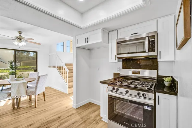 a kitchen with stainless steel appliances a stove a microwave and cabinets