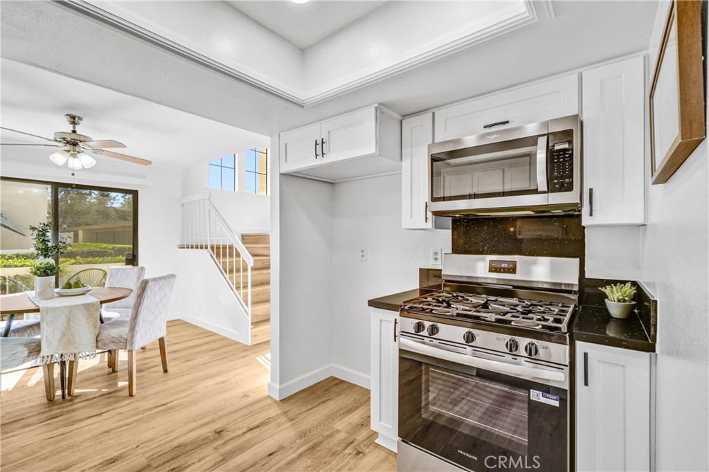 3110 Cochise Way, Unit 91 Fullerton, CA 92833 - Photo 11 of 25 a kitchen with stainless steel appliances a stove a microwave and cabinets