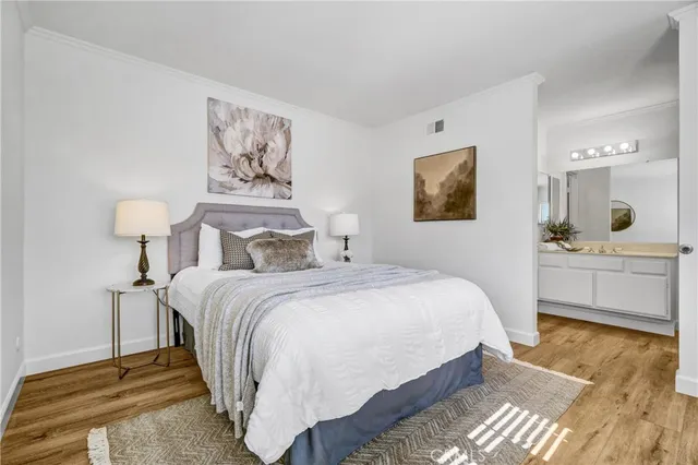 a bedroom with bed and a chandelier