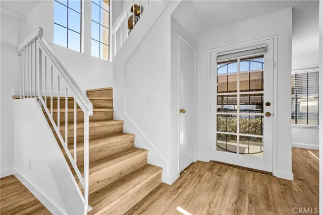 a view of staircase with wooden floor and a window