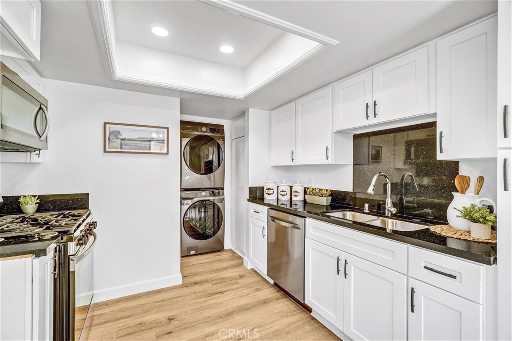 3110 Cochise Way, Unit 91 Fullerton, CA 92833 - Photo 8 of 25 a kitchen with stainless steel appliances granite countertop a stove a sink and a refrigerator
