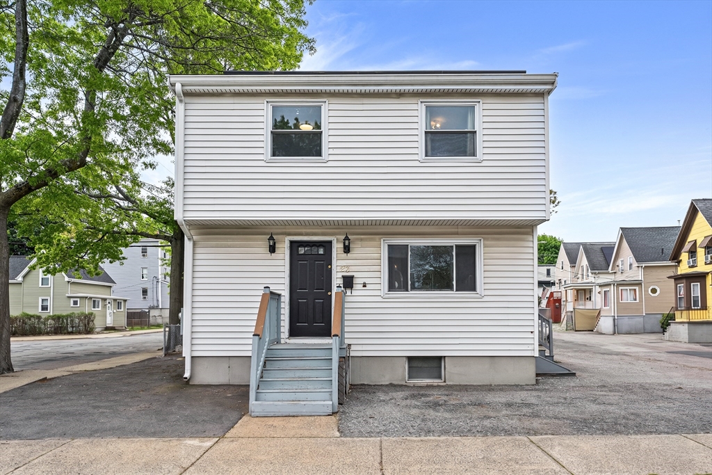 23 Logan Street Lynn, MA 01902 - Photo 2 of 27 a view of a house with a yard and garage