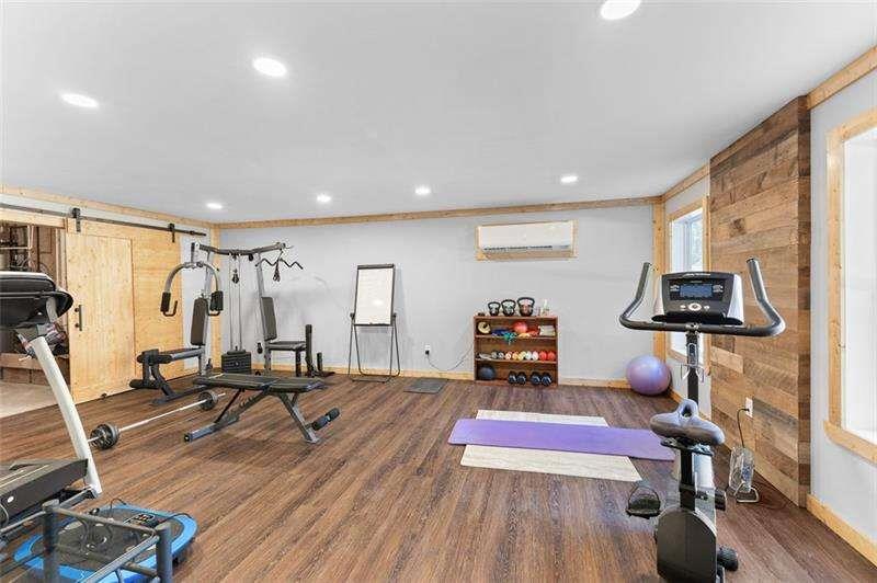 629 Dee Kennedy Road Winder, GA 30680 - Photo 54 of 67 a room with furniture gym equipment and a flat screen tv