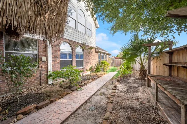 a view of a pathway with a house in the background
