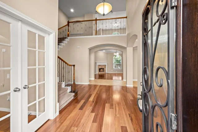 a view of a livingroom with wooden floor and furniture