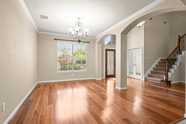 wooden floor in an empty room with a window