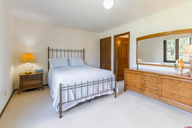 a large bed sitting in a room next to a window