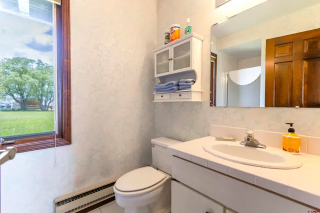 a bathroom with a sink toilet and mirror