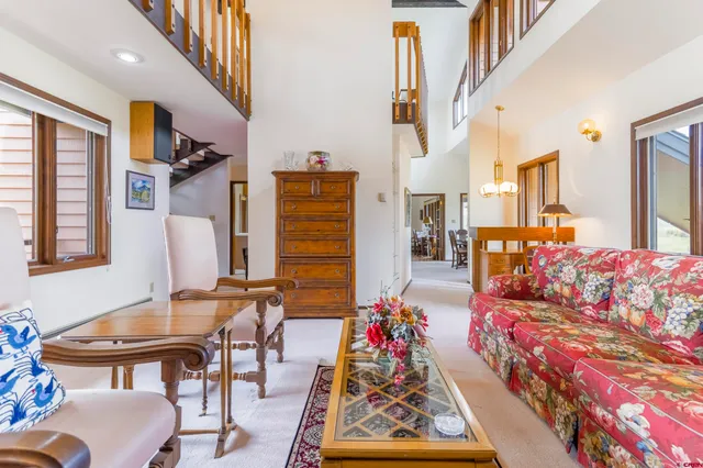 a living room with furniture and a dining table