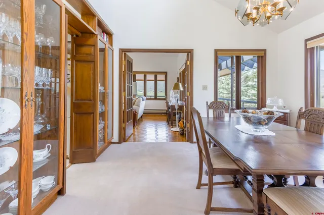 a view of a a dining room with furniture window and wooden floor