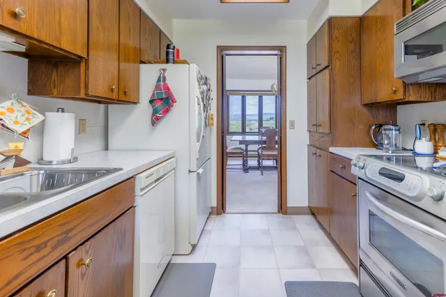 a kitchen with stainless steel appliances granite countertop a sink and cabinets