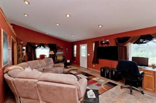 a living room with furniture a rug and a flat screen tv
