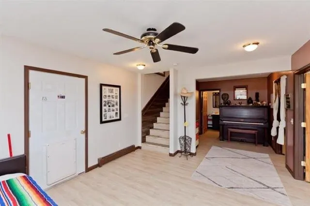 a spacious bedroom with a bed and a flat screen tv