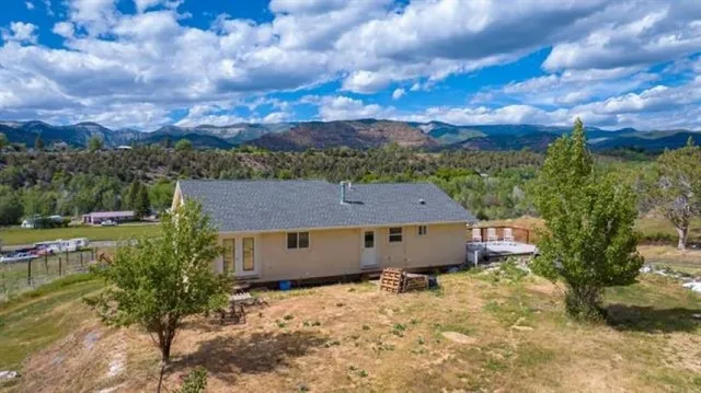 an aerial view of a house with outdoor space