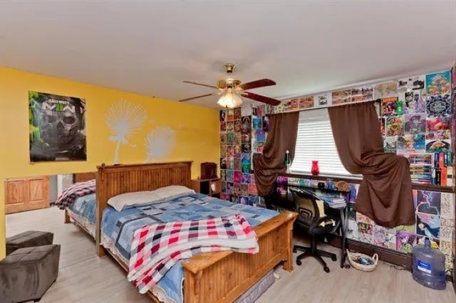 a bedroom with a bed and a chandelier