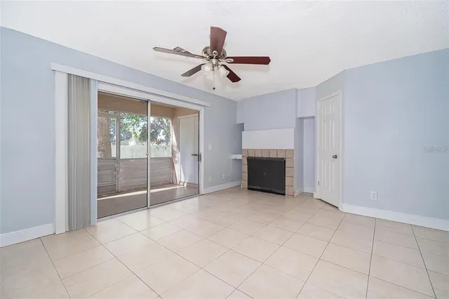 a view of an empty room with a fireplace