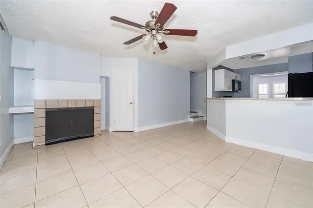 a view of kitchen with furniture and a ceiling fan