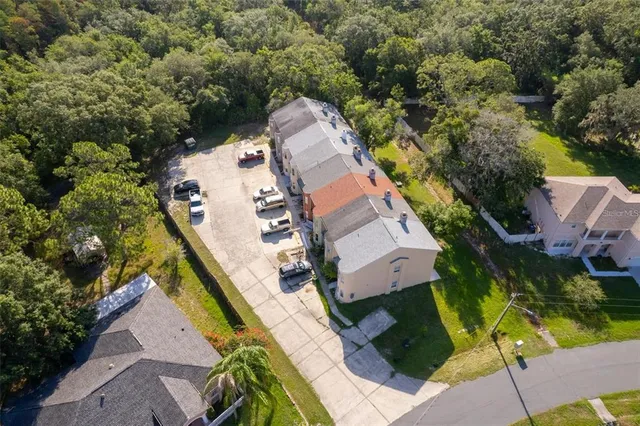 an aerial view of a house with a yard