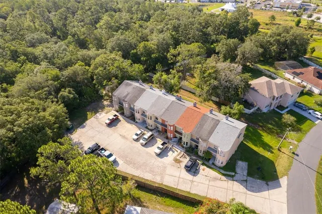 an aerial view of multiple houses with yard