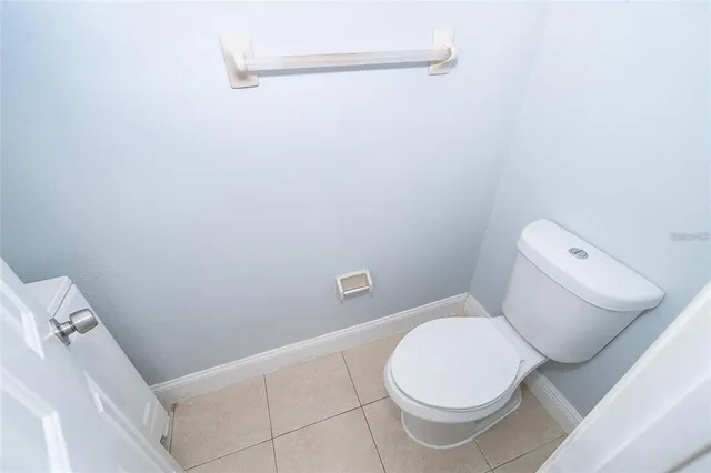 a white toilet sitting next to a bath tub
