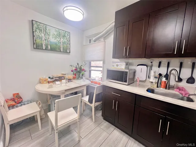 a kitchen with a sink cabinets and wooden floor