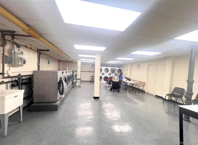 a living room with furniture and a gym machine