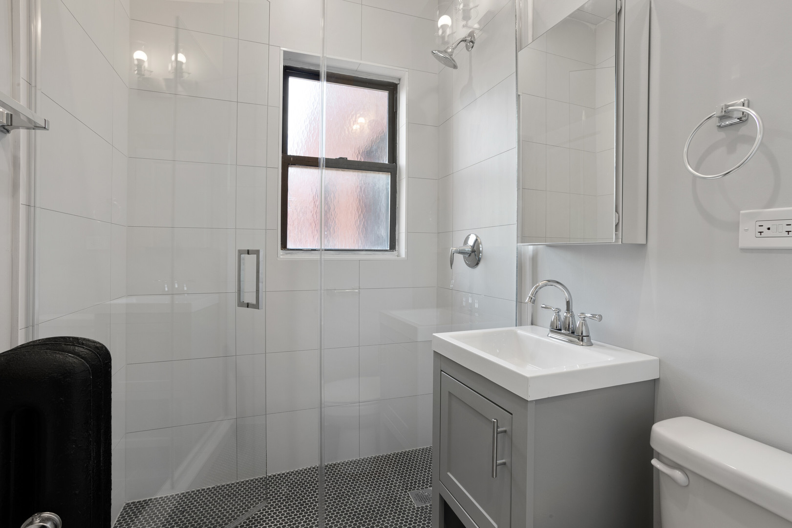 1704 West Juneway Terrace, Unit 3F Chicago, IL 60626 - Photo 11 of 13 a bathroom with a sink a toilet and shower