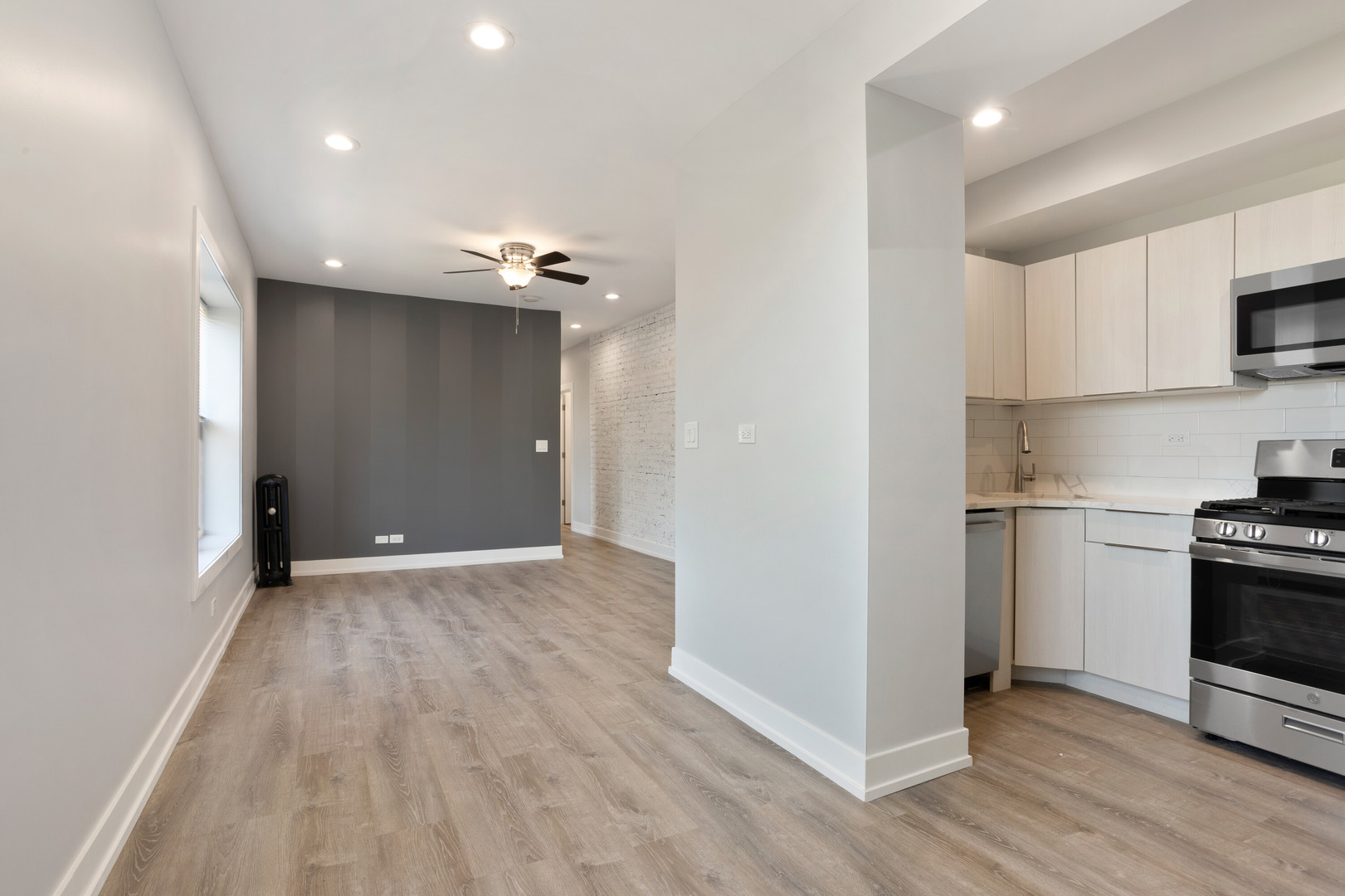 1704 West Juneway Terrace, Unit 3F Chicago, IL 60626 - Photo 3 of 13 a view of a kitchen with a sink and a refrigerator