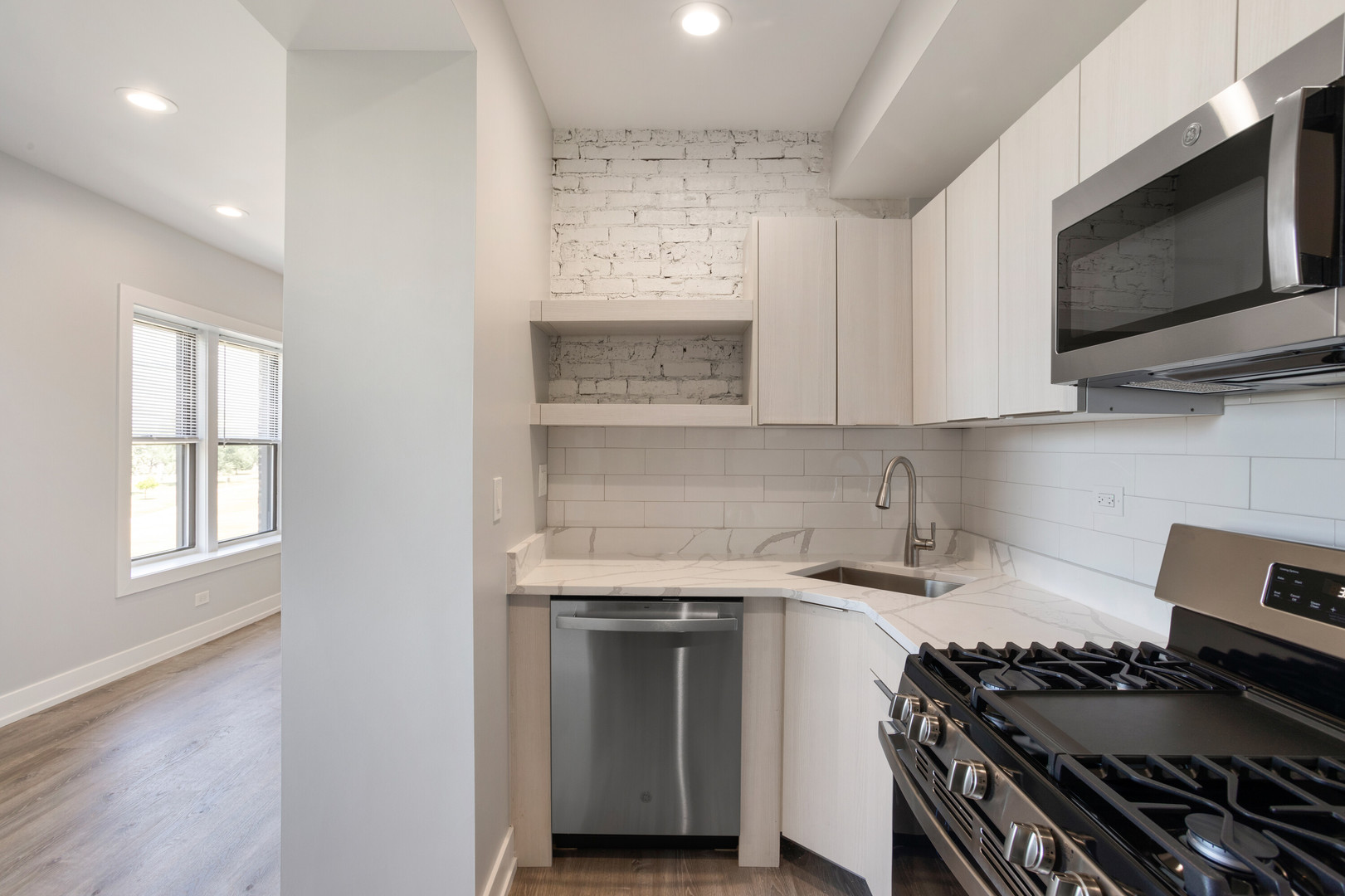 1704 West Juneway Terrace, Unit 3F Chicago, IL 60626 - Photo 4 of 13 a kitchen with stainless steel appliances a stove and a microwave