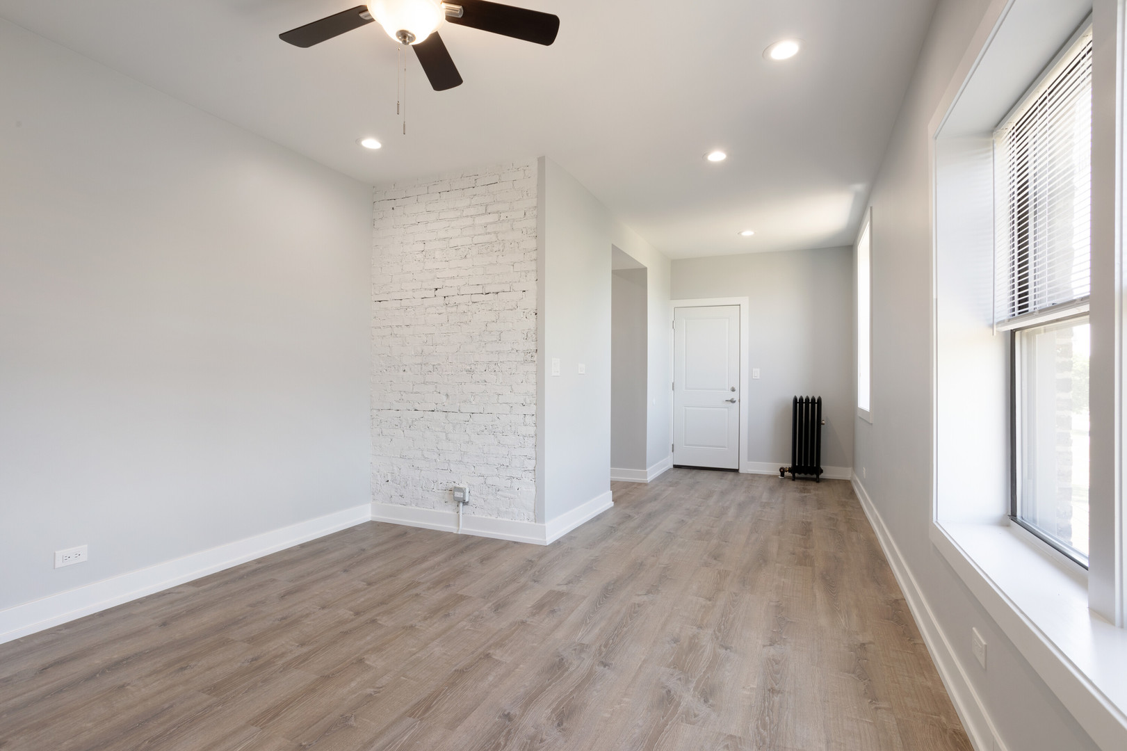 1704 West Juneway Terrace, Unit 3F Chicago, IL 60626 - Photo 5 of 13 wooden floor in an empty room with a window