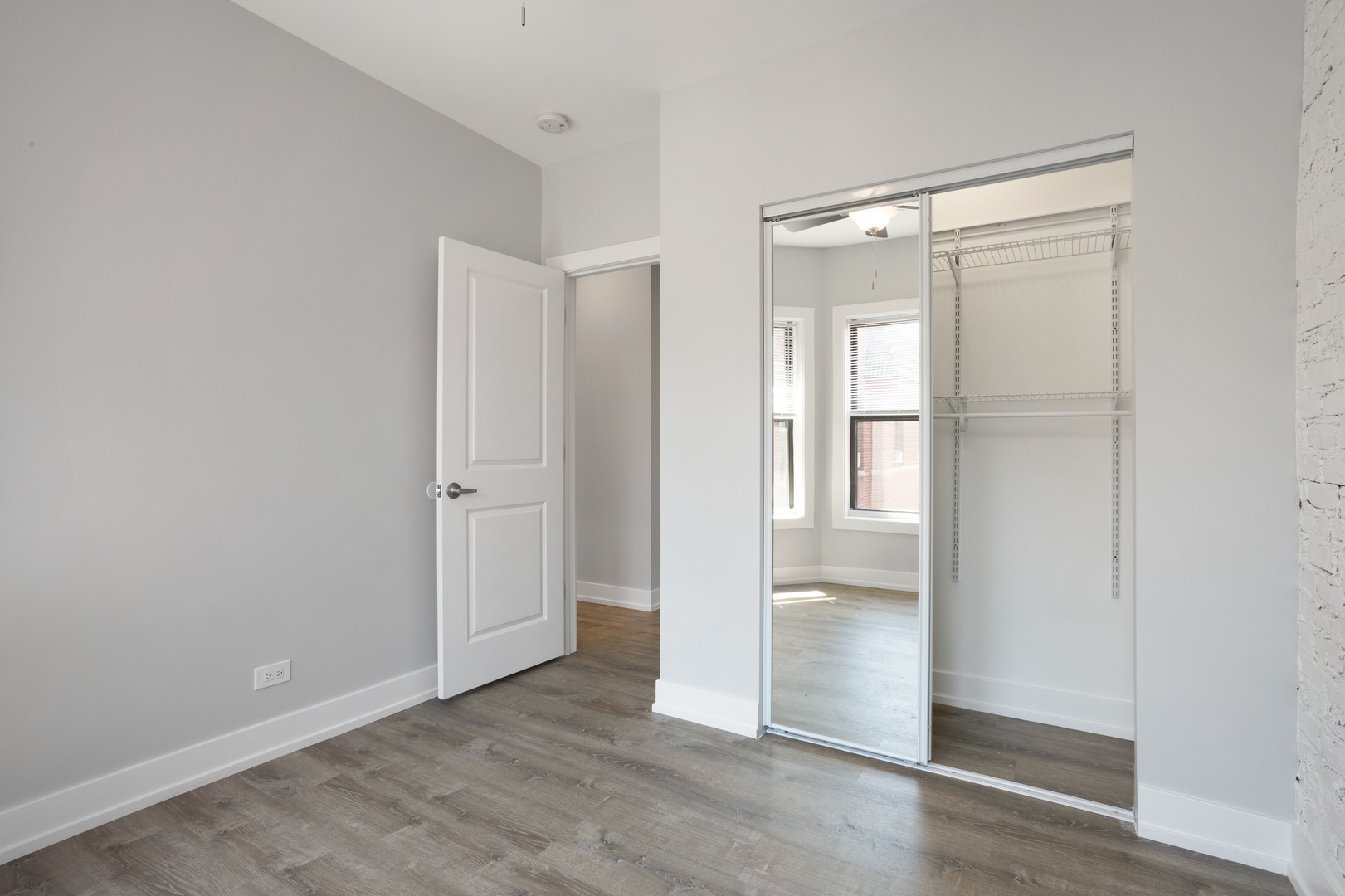 1704 West Juneway Terrace, Unit 3F Chicago, IL 60626 - Photo 10 of 13 a view of an empty room with wooden floor and a window