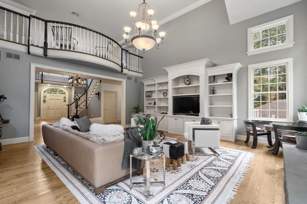 137 Lake Street Sherborn, MA 01770 - Photo 11 of 42 a living room with furniture chandelier and a flat screen tv