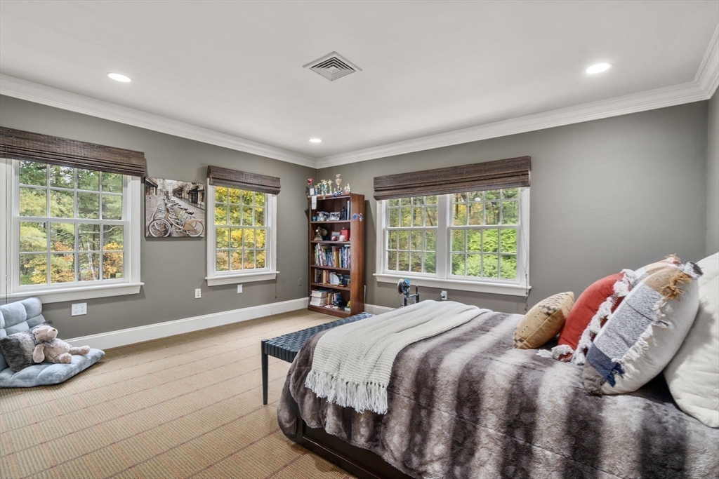 137 Lake Street Sherborn, MA 01770 - Photo 18 of 42 a bed sitting in a spacious bedroom next to a window
