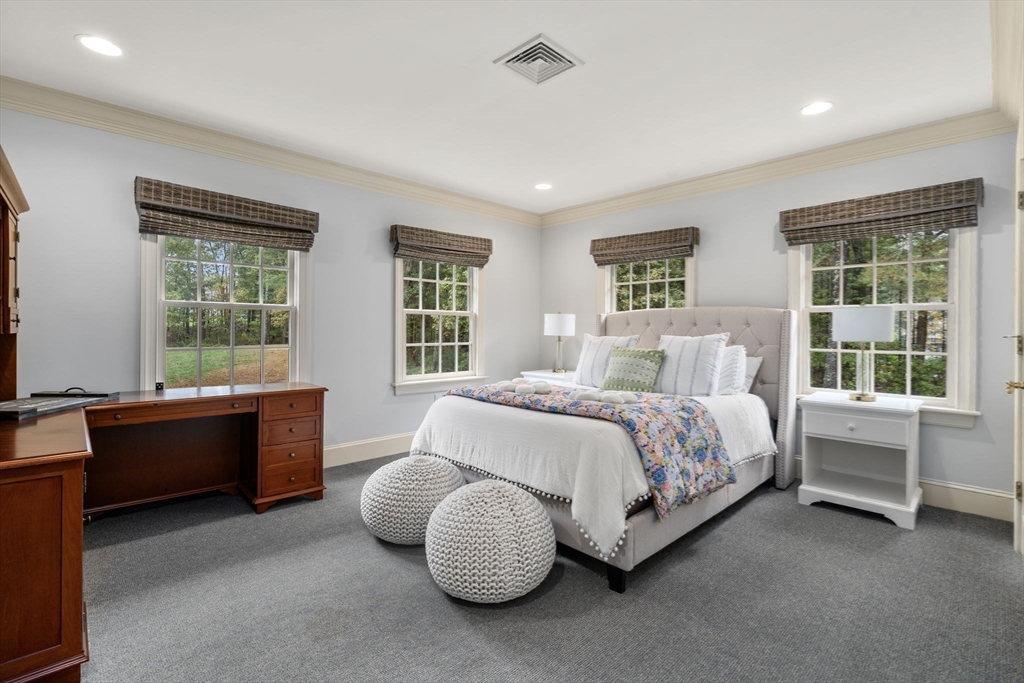 137 Lake Street Sherborn, MA 01770 - Photo 19 of 42 a bed sitting in a spacious bedroom next to a window