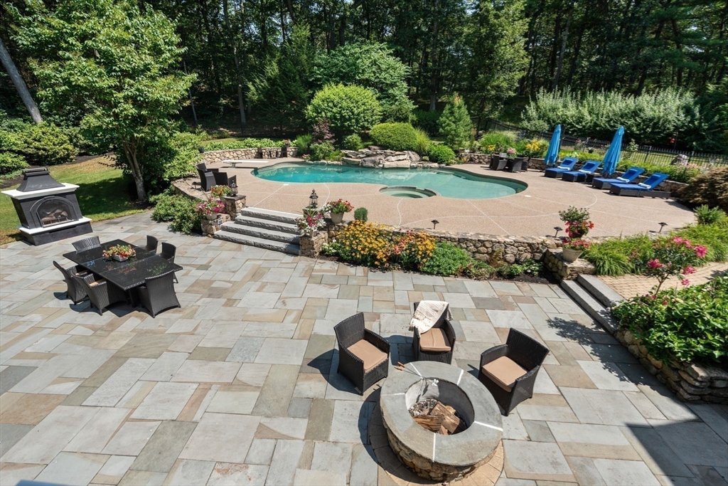 137 Lake Street Sherborn, MA 01770 - Photo 37 of 42 a view of a backyard with table and chairs potted plants and large tree