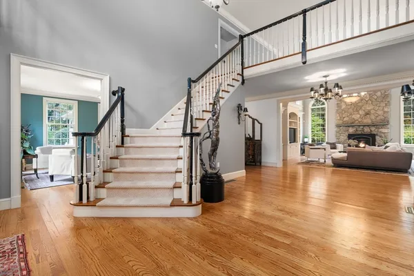 a view of staircase and living room with wooden floor