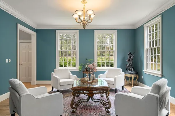 a living room with fireplace furniture and a large window