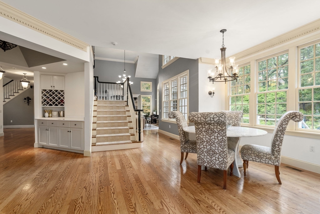 137 Lake Street Sherborn, MA 01770 - Photo 9 of 42 a view of a dining room and livingroom with furniture wooden floor a chandelier