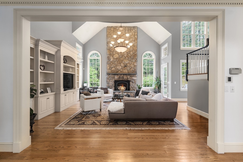 137 Lake Street Sherborn, MA 01770 - Photo 10 of 42 a living room with fireplace furniture and a chandelier