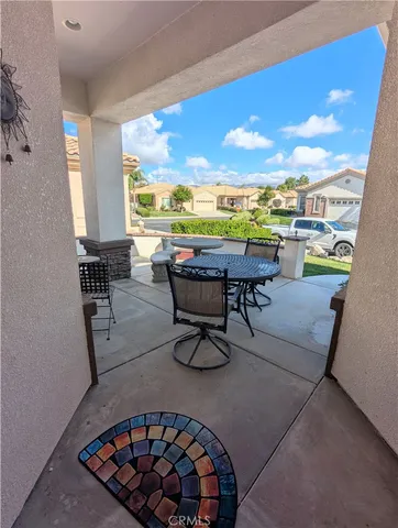 a balcony with chairs and table